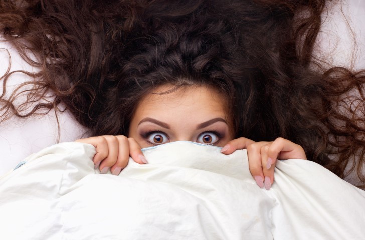 anxiuous girl covering mouth hiding from dentist